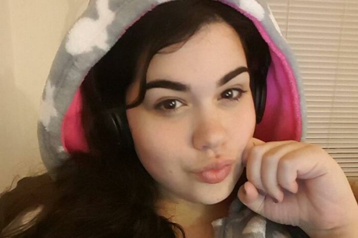 Amber smirks in a bunny hoodie.