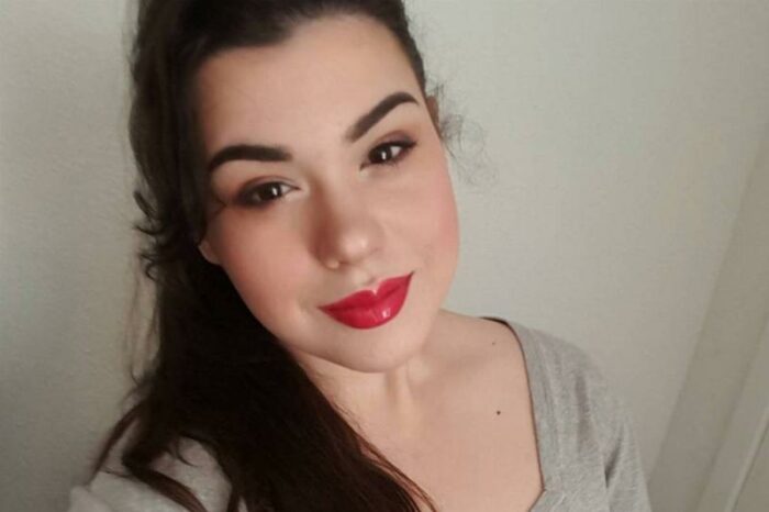 Amber smiles while wearing red lipstick.