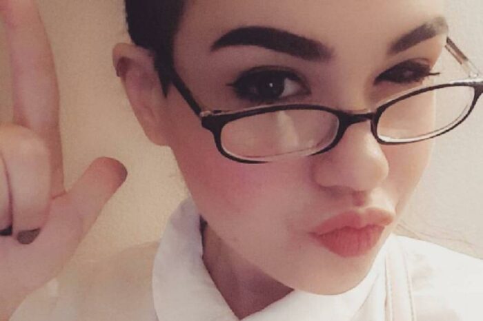 Amber purses her lips and wears glasses in a selfie.